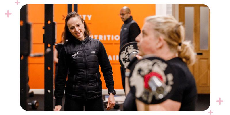 Charlotte Price of Hunt Fitness coaching a member who is weightlifting